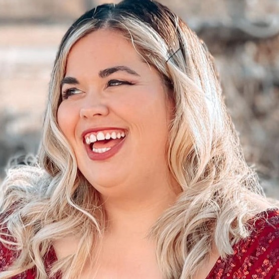 white woman with long blond hair smile brightly