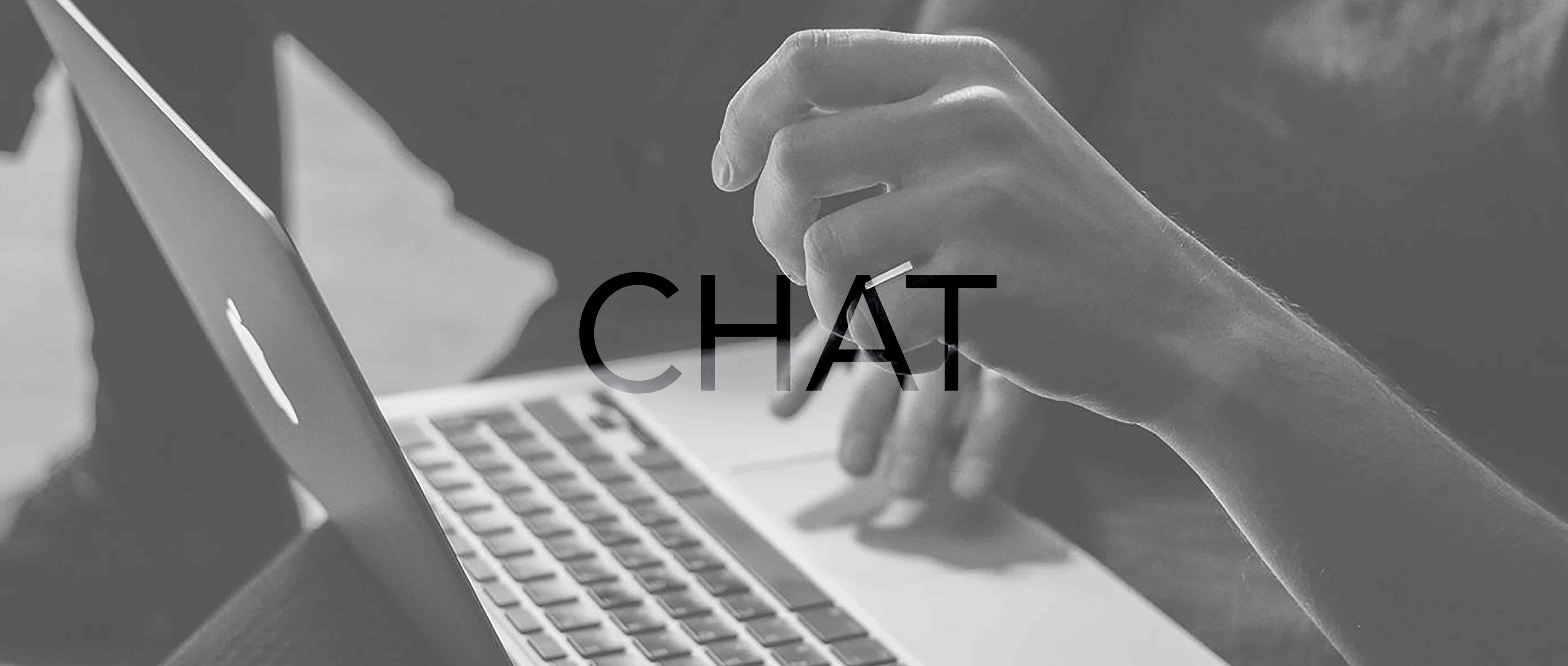 Chat: black and white image of a closeup of hands typing on a keyboard